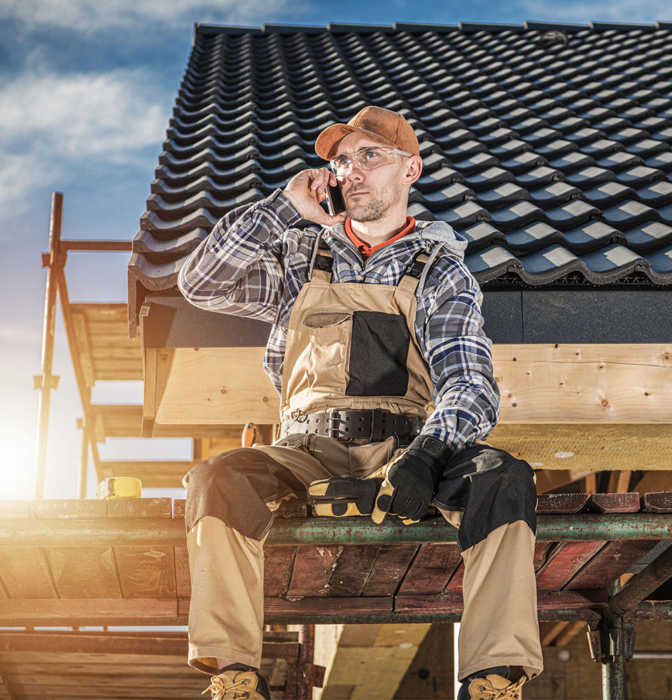 Roofer on the phone in on construction site