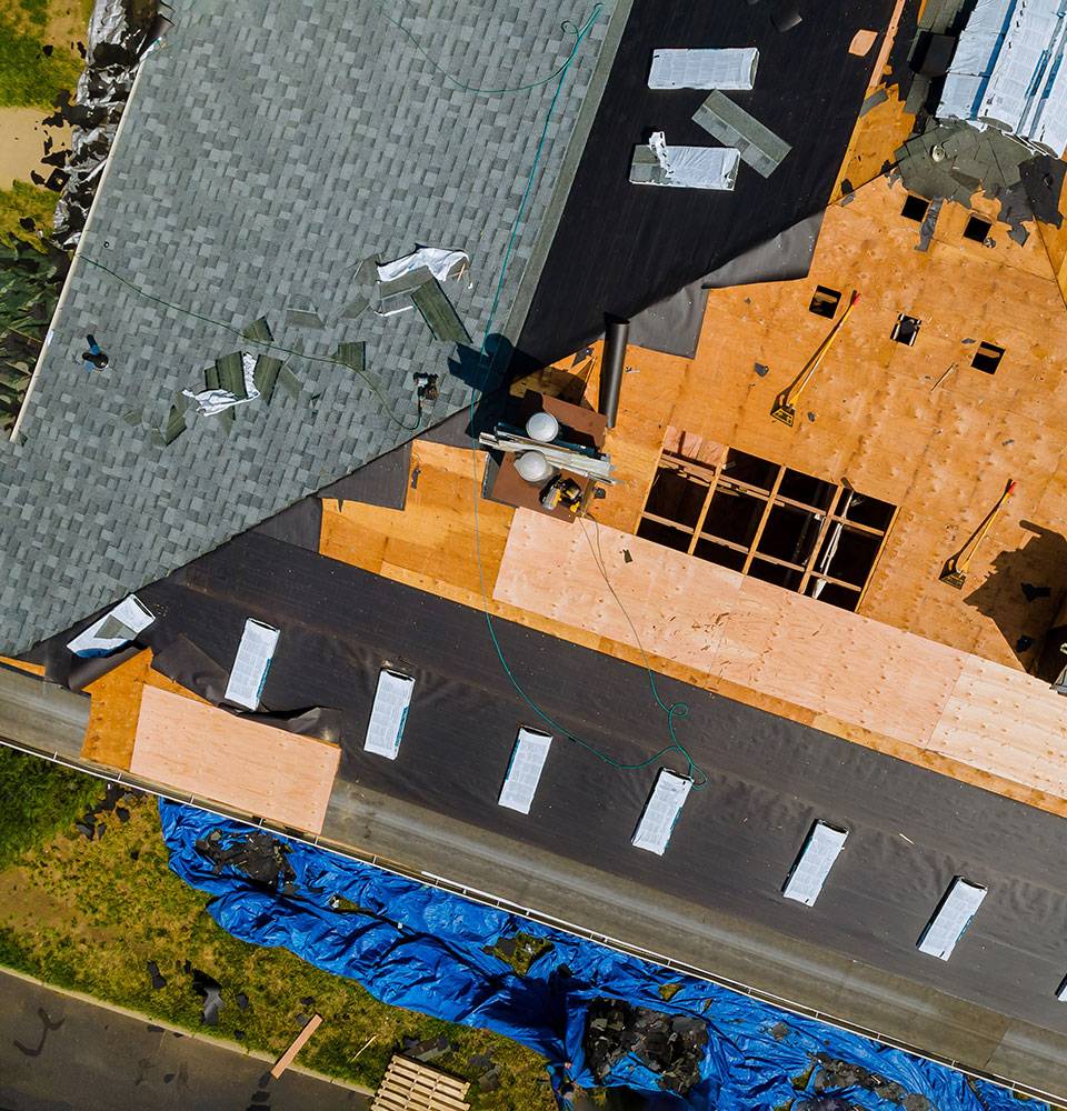 Roofers working on roof that is half finished